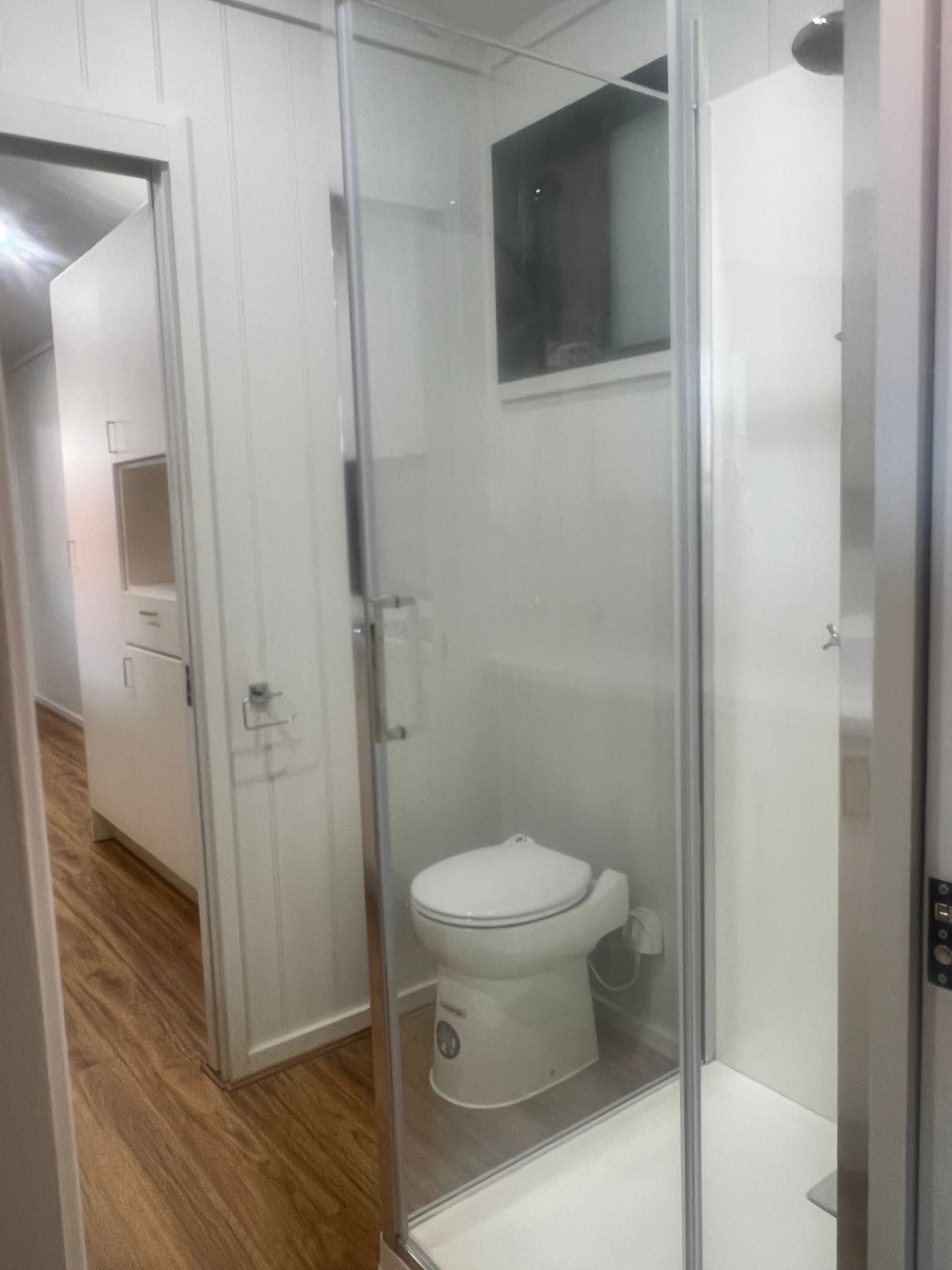 Bathroom view of the Tiny Grandeur tiny house on wheels, showing the sleek finishes