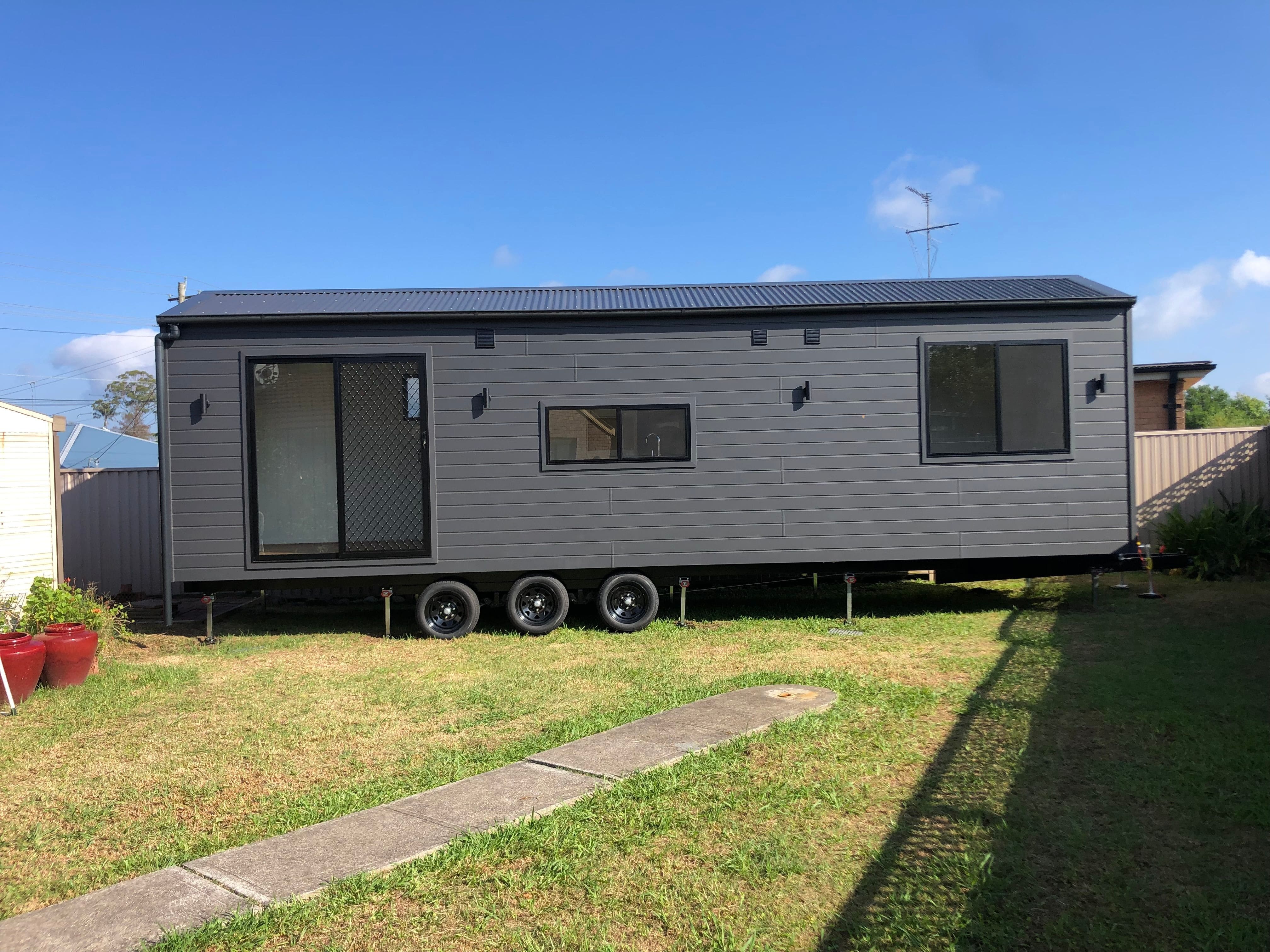 The Tiny Grandeur tiny house on wheels positioned in its new location ready to be moved into.