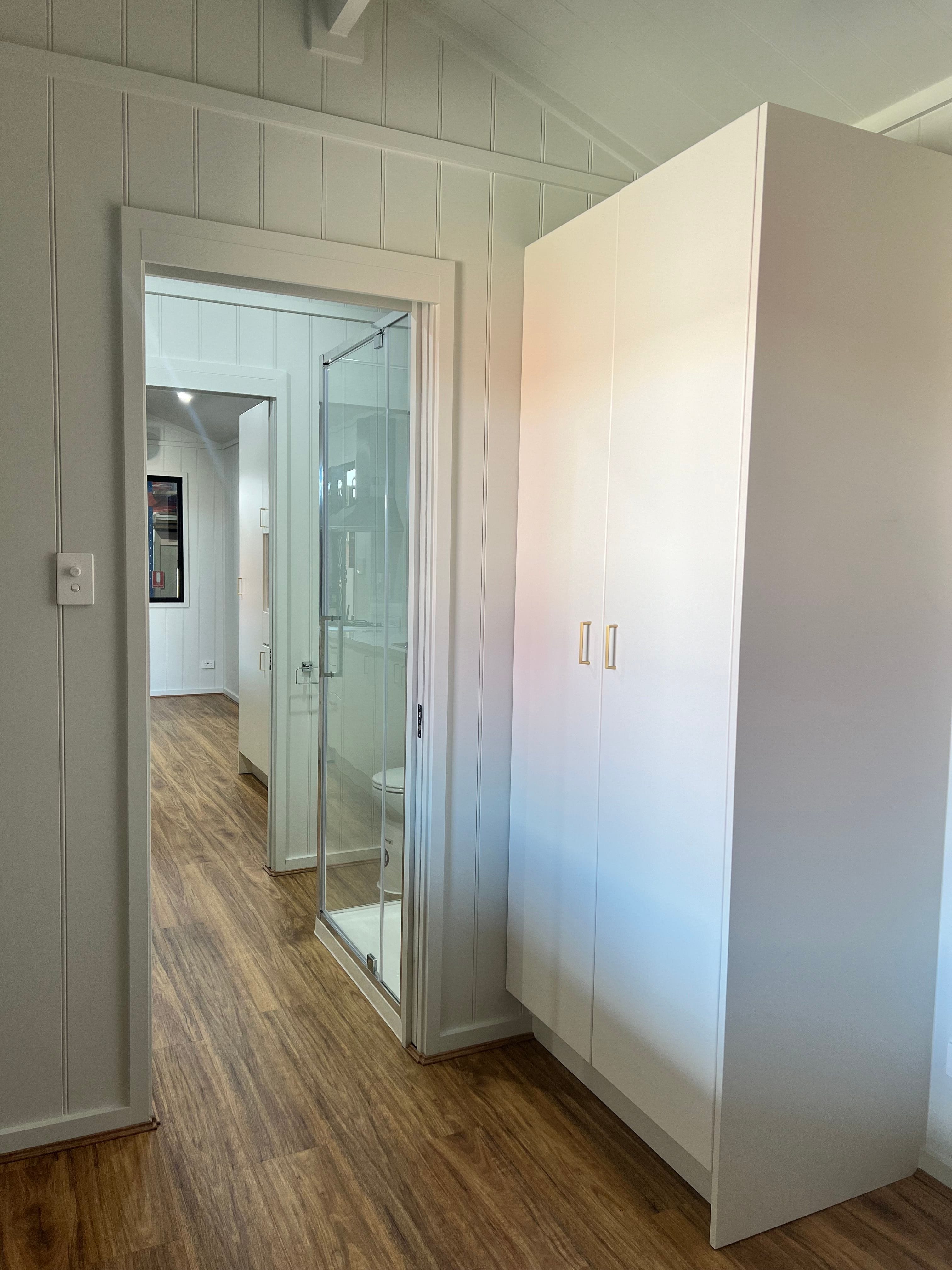 Interior view of the Tiny Grandeur tiny house on wheels, showcasing a well-organized and cozy space.