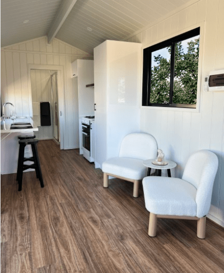 Interior view of the flowing design of the  living area of the Tiny Voyager tiny house on wheels