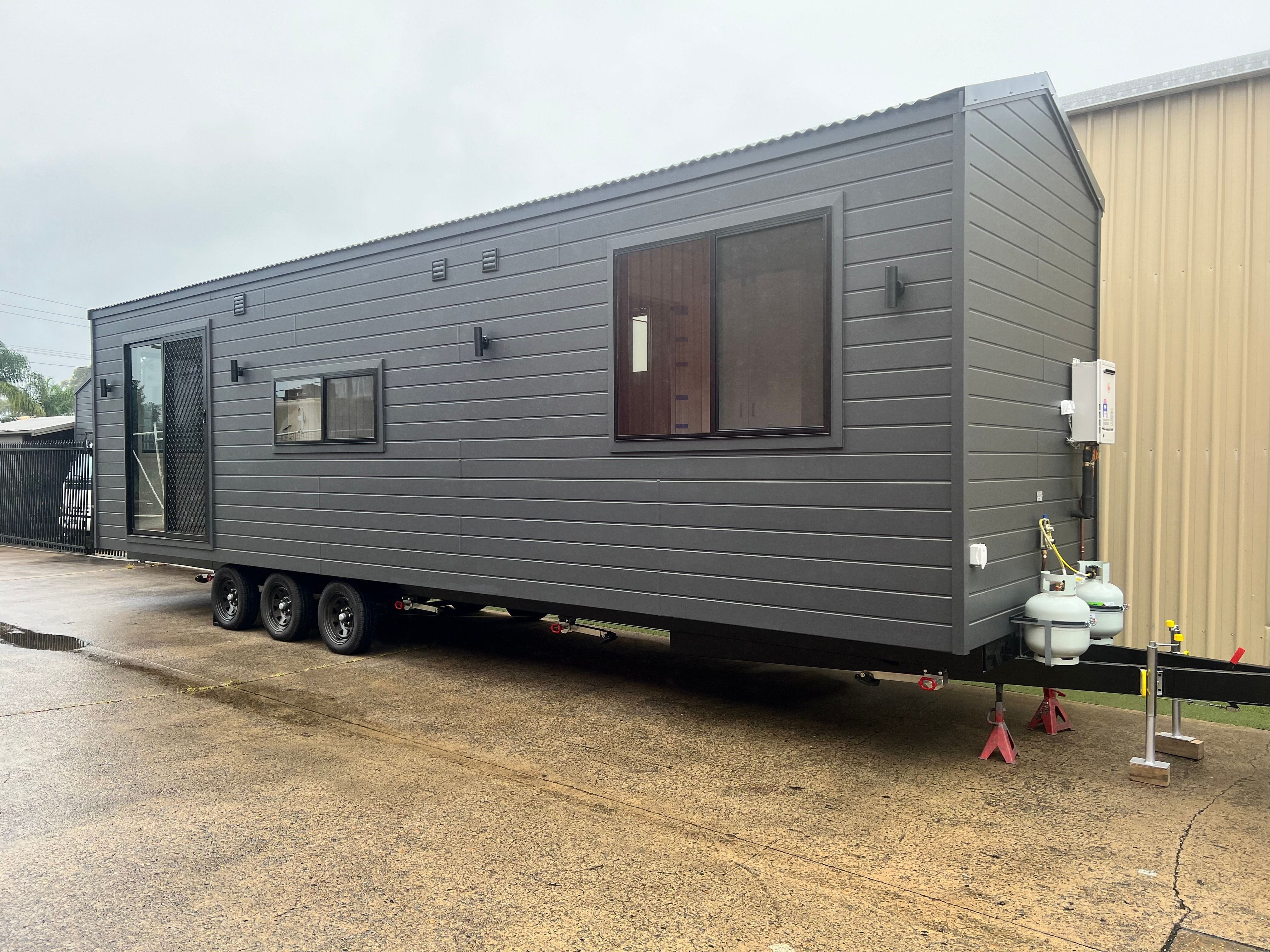 Exterior view of a Tiny Grandeur tiny house on wheels, ready for delivery.