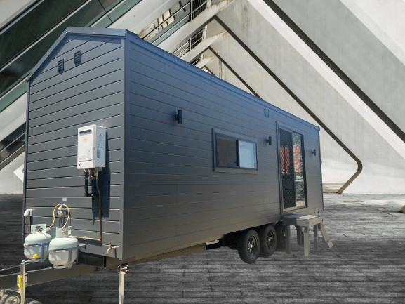 "Tiny Voyager: A cozy and stylish tiny home on wheels, designed for sustainable living and adventure."