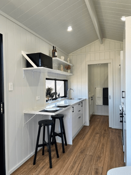 Beautiful interior view of the stylish kitchen of the Tiny Voyager tiny house on wheels